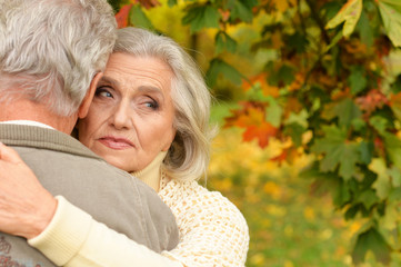 Portrait of sad senior couple in autumn park