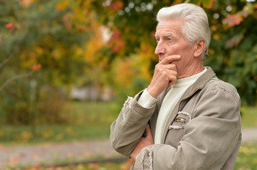 portrait of sad senior man in park