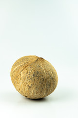 Closeup coconut of organic tropical fruit, hard white large nut with hollow center filled with milky juice, popular fruit use for Thai cooking and many kind of dessert isolated on white background.