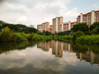 Fototapeta na wymiar Residential area behind the park divided by a small river