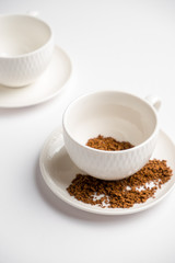 white coffee cups with instant coffee on a white background