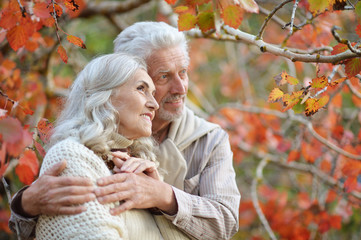 Portrait of happy senior woman and man in park