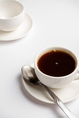 white cup for coffee with a spoon on a white background