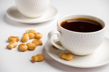 white coffee cups with cookies on white background