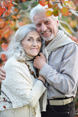 Portrait of happy senior woman and man in park