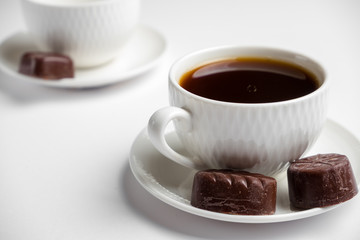 white cup for coffee with sweets on a white background