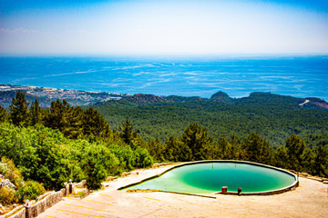 View from the mountain to the pool and the forest, the sea and the blue sky.