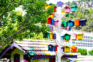 Fototapeta na wymiar A pillar with multicolored nesting boxes.