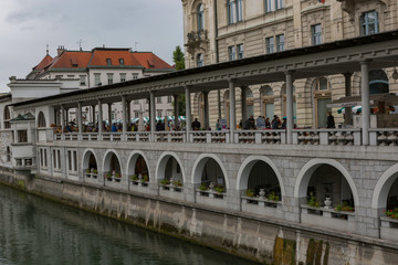 Fototapeta na wymiar Ljubljana,Slovenia,6,2016: Street, river, bridges with dragons, magical city.