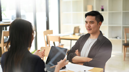 Young man and woman meeting a startup business women and man working in co working space.