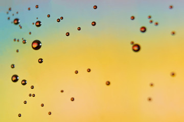 beautiful vials of air in water on a multi-colored background.The texture of water on the glass