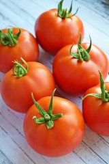 Delicious,ripe tomatoes on a wooden background.Healthy diet.