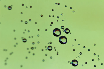 beautiful vials of air in water on a multi-colored background.The texture of water on the glass