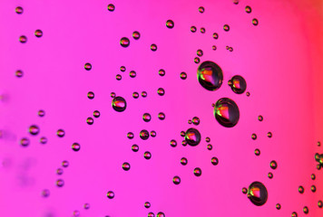 beautiful vials of air in water on a multi-colored background.The texture of water on the glass