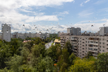Fototapeta na wymiar Water drops on the window glass on background of Moscow