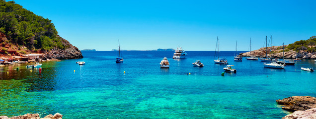 Panorama of sailboats at Cala Salada lagoon. Idyllic scenery. Ibiza, Balearic Islands. Spain