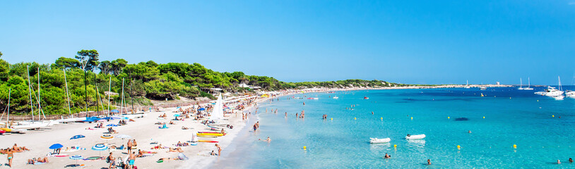 Panoramic image people swimming and sunbathing on the picturesque Las Salinas beach. Ibiza,...