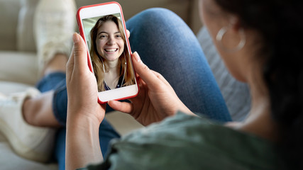 Young woman using smartphone for video call - obrazy, fototapety, plakaty