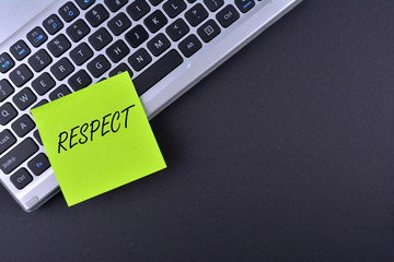 Sticky note on keyboard with text RESPECT