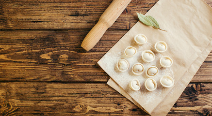Raw Russian traditional dumplings on wooden background
