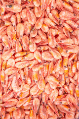 Frozen king prawns in a supermarket. Close-up. Vertical. Space for text.