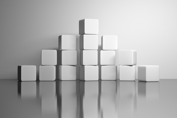 Pyramid made of white plain cubes standing on white reflective mirror surface