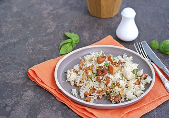 Pilaf with chanterelles and chicken on brown clay plate. Cooking wild mushrooms. Mushroom season recipes.