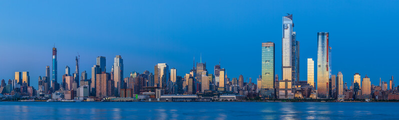 View to Manhattan skyline from Weehawken Waterfront in  Hudson River at sunset.