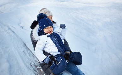 Mother and child tobogganing