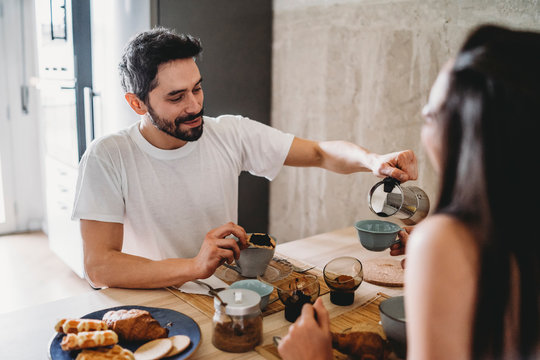 Couple having breakfast at kitchen table