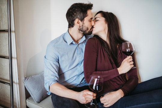 Young couple drinking red wine in a relaxing moment