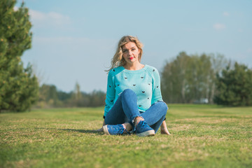 Fototapeta premium Nice European or American plump girl at park, concept of modern women lifestyle, walk in autumn time 