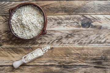Bran oat in bowl in wooden background
