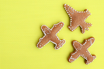 Fototapeta na wymiar Gingerbreads in a shape of airplane on bright yellow background
