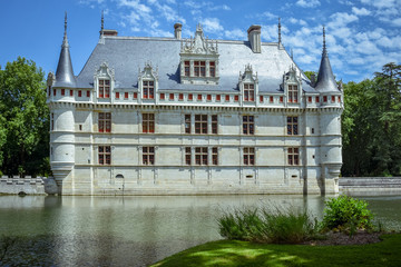 Fototapeta na wymiar One of the earliest French Renaissance castle. Built on an island in the Indre River. Sunny day in summertime at Azay le Rideau castle, France on July 06, 2017