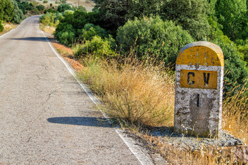spanish stone mileposts in a antique road without service