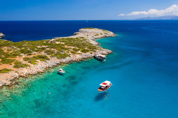 Aerial view of swimmiers and snorkellers in a hot, crystal clear ocean (Crete, Greece)