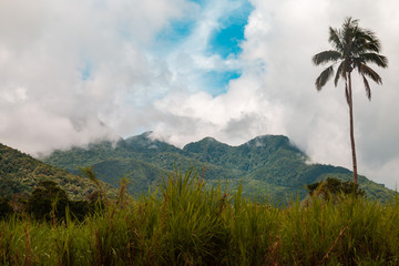Fototapeta na wymiar Clouds over towering volcanic peaks on Camiguin Island, Philippines