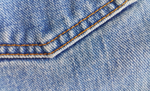 Fragment of classic blue fashioned jeans