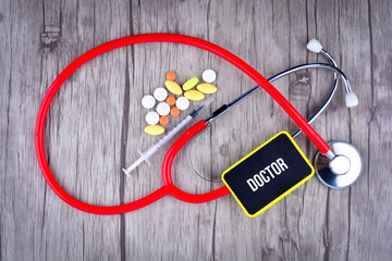 Pills, Syringe and Stethoscope with text Doctor