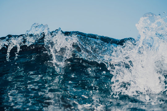 Close up detail shot of a small breaking wave