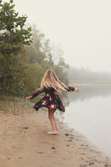Blond girl enjoying lake