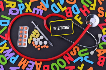 Stethoscope, syringe and medicine with text INTERNSHIP