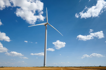 wind generator on bright cloudy sky background