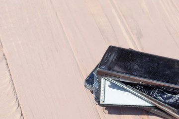 daylight. broken mobile phone. wooden background. have toning