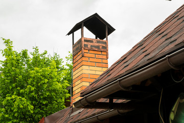 stone chimney on the roof of a building