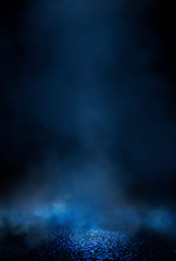 Empty street scene background with abstract spotlights light. Night view of street light reflected on water. Rays through the fog. Smoke, fog, wet asphalt with reflection of lights. 