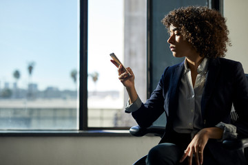Businesswoman using smartphone in office