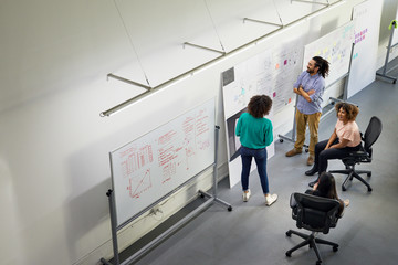 High angle view of colleagues brainstorming in meeting at office