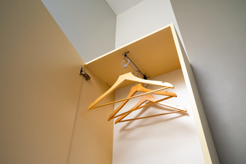 wooden hangers in the closet with sliding system, hangers for outerwear